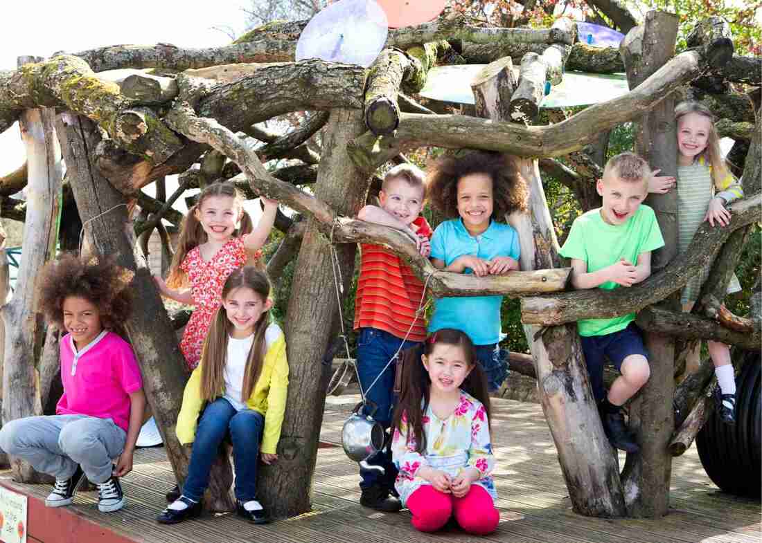 Children smiling in Wooden Adventure Playhouse