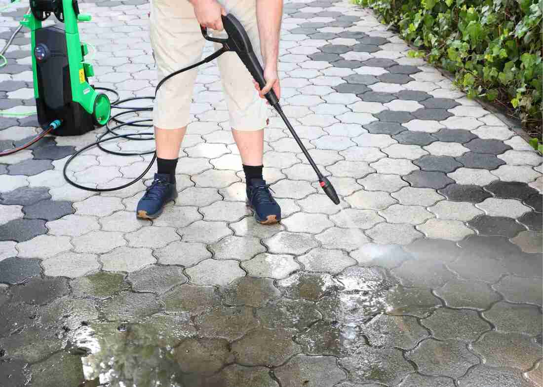 Handyman Cleaning Driveway with High Pressure Cleaning Wand